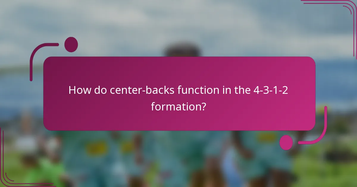 How do center-backs function in the 4-3-1-2 formation?